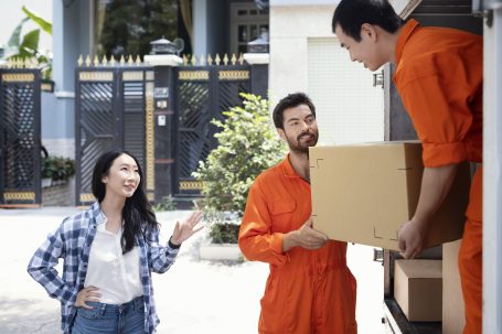 delivery-men-unloading-box-customer